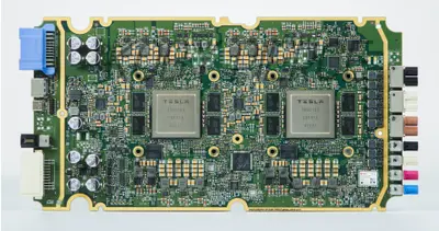Macro photograph of a Tesla Full Self-Driving computer board showing its two custom Tesla neural network processors