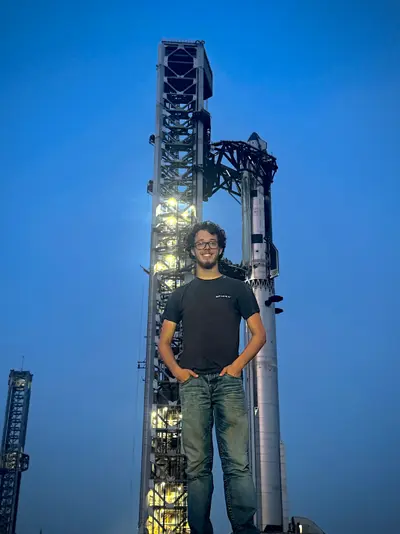 Koby Pierce standing in front of SpaceX Starship at Starbase