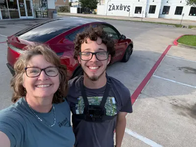 Koby and Sheri in Houston with the Robotaxi behind them