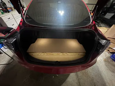 The slanted wood and fiberboard dry-fitted in the trunk without any wrapping